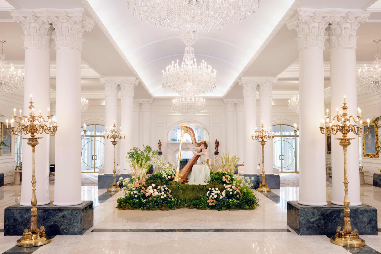 A warm and inviting interior shot of The Chateau's lobby, featuring elegant furnishings, high ceilings, and intricate details, creating an ambiance of sophistication.